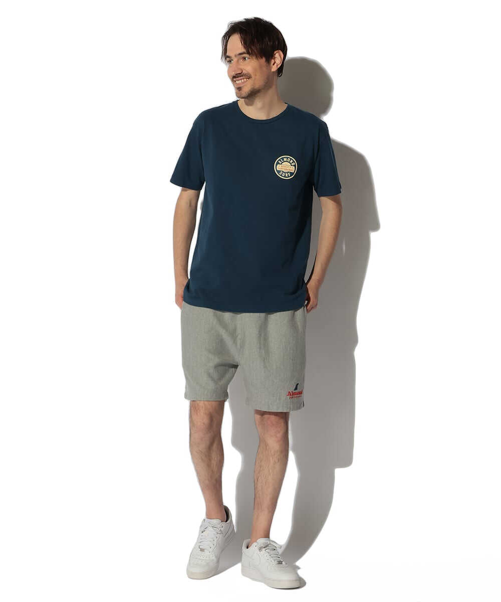 バッジロゴ バックプリント コットンTシャツ